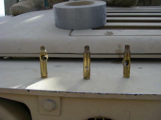 5.56 cartridges with bullet holes through them